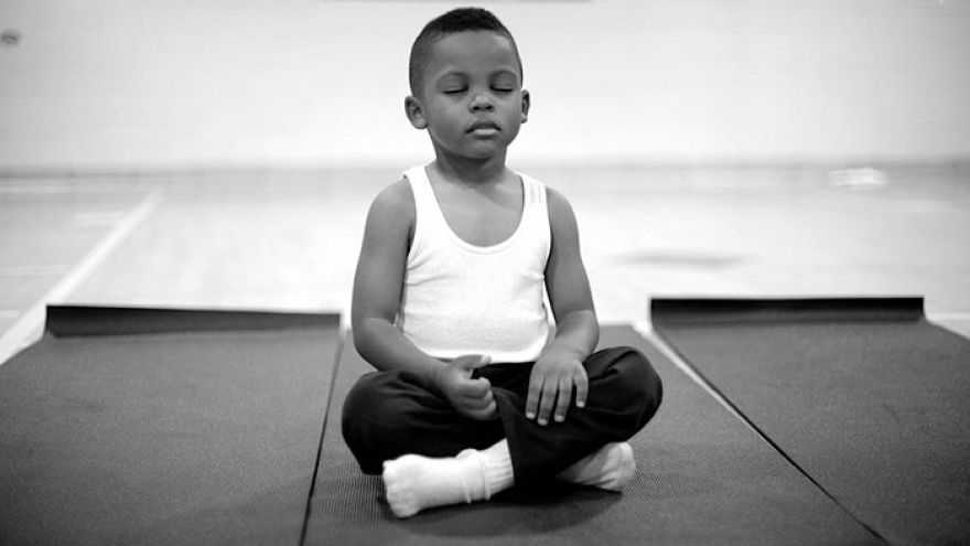 V základnej škole v americkom Baltimore sa rozhodli bojovať s neposlušnými deťmi pozitívnym spôsobom. Meditujú s nimi.